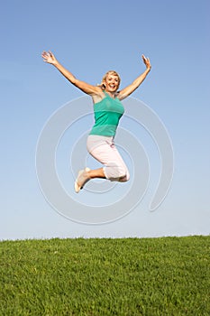 Senior woman jumping in air