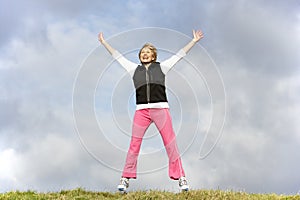 Senior Woman Jumping In Park