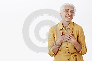 Senior woman keep getting compliments looking fresh and beautiful. Delighted happy charming old lady with white hair in