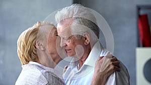 Senior woman kissing her husband on cheek