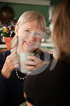 Senior woman in kitchen with daughter or friend