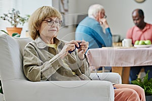 Senior woman knitting during her leisure time