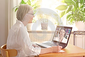 Senior woman laptop online therapy photo