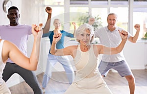 Senior woman learning to dance krump in modern choreographic studio