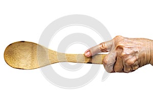 Senior woman left hand holding wooden ladle on white background, Close up shot, Selective focus, Kitchen utensils concept