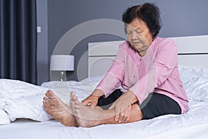 Senior woman with leg pain in bed