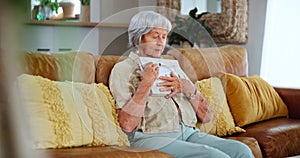 Senior woman, living room and sad with photo frame in sofa for memories with grief, lonely and emotional for loss. Widow