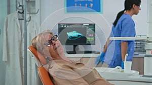 Senior woman looking on camera waiting on dental clinic