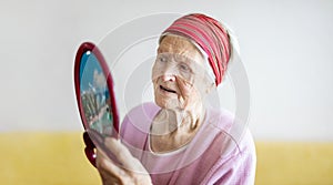 Senior woman looking at herself in mirror