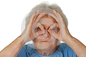 Senior woman looking through imaginary binocular