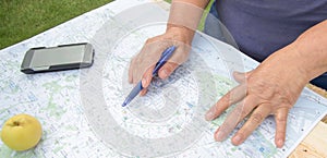 Senior woman looking at a map of Barcelona preparing for a trip, tourism in Europe.