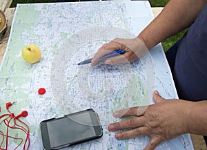 Senior woman looking at a map of Barcelona preparing for a trip, tourism in Europe.