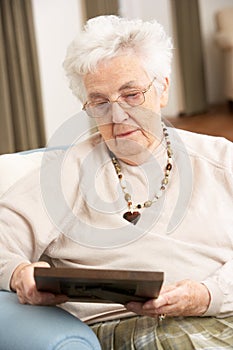 Senior Woman Looking At Photograph