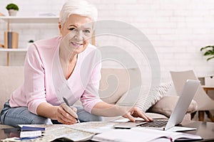 Senior woman looking planning travel with map