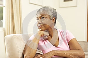 Senior Woman Looking Thoughtful In Chair