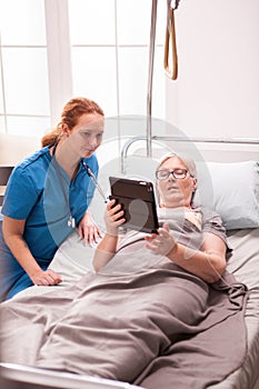 Senior woman lying in nursing home bed