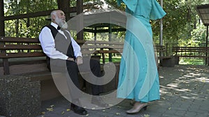 Senior woman makes a curtsy and happy elderly couple start dancing