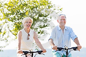 Senior woman and man at bicycle tour
