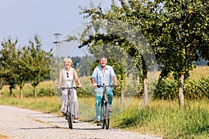 Senior woman and man at bicycle tour