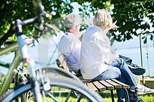 Senior woman and man at rest on bike trip