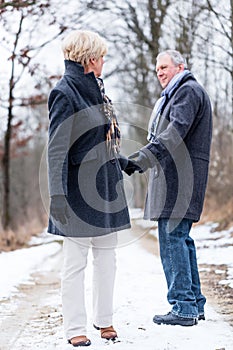 Senior woman and man saying goodbye