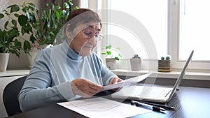 Senior Woman Managing Documents at Home