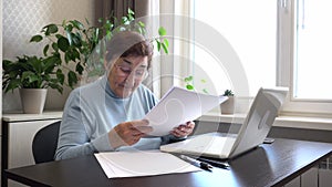 Senior Woman Managing Documents at Home