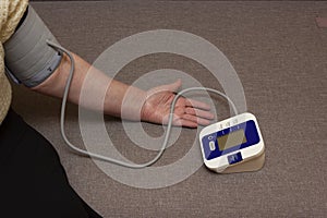 Senior woman measuring her blood pressure at home.pressure measurement with a tonometer blood pressure monitor