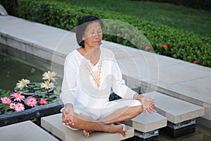 Senior woman meditation on park