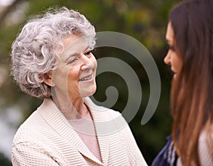 Senior woman, mother and daughter with smile for love, bonding and visit from relatives outdoor in backyard, garden and