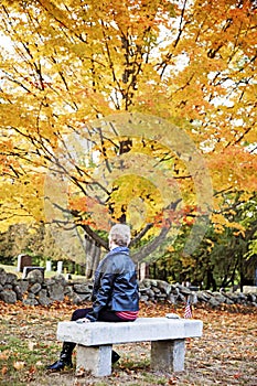 Senior woman mourning in cemetery