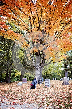 Senior woman mourning in cemetery