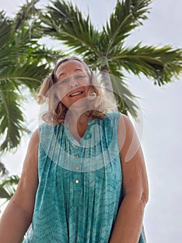 Senior Woman Next to Palm Tree