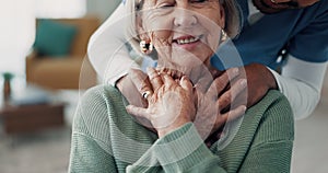 Senior woman, nurse and hug for support with a smile at a nursing home in retirement. Elderly female patient with a