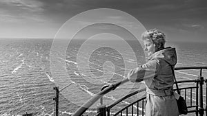 Senior Woman overlooking a Stormy Lake