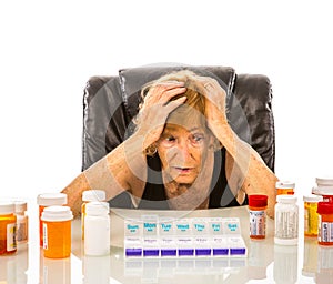 Senior Woman Overwhelmed With Pill Choices For Her Pill Box