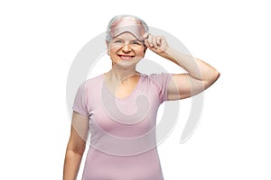 senior woman in pajamas and eye sleeping mask