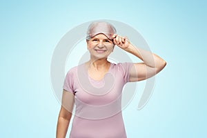 senior woman in pajamas and eye sleeping mask