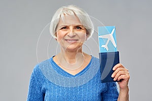 Senior woman with passport and airplane ticket