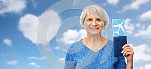 Senior woman with passport and airplane ticket