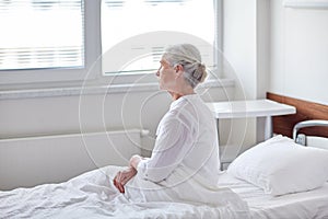 Senior woman patient lying in bed at hospital ward