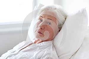 Senior woman patient lying in bed at hospital ward