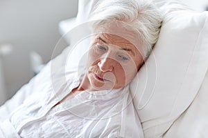 Senior woman patient lying in bed at hospital ward