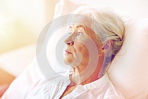 Senior woman patient lying in bed at hospital ward