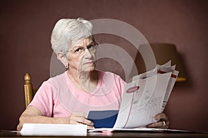 Senior woman paying bills