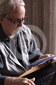 Senior Woman Paying Bills With Laptop