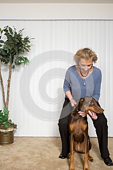 Senior woman with pet Doberman