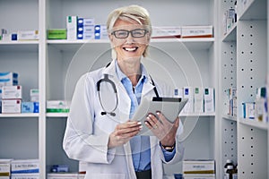 Senior woman, pharmacist and clinic tablet portrait with medical stock and digital research. Pharmacy, healthcare store