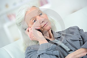 Senior woman with phone feel unwell