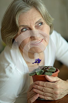 Senior woman with plant